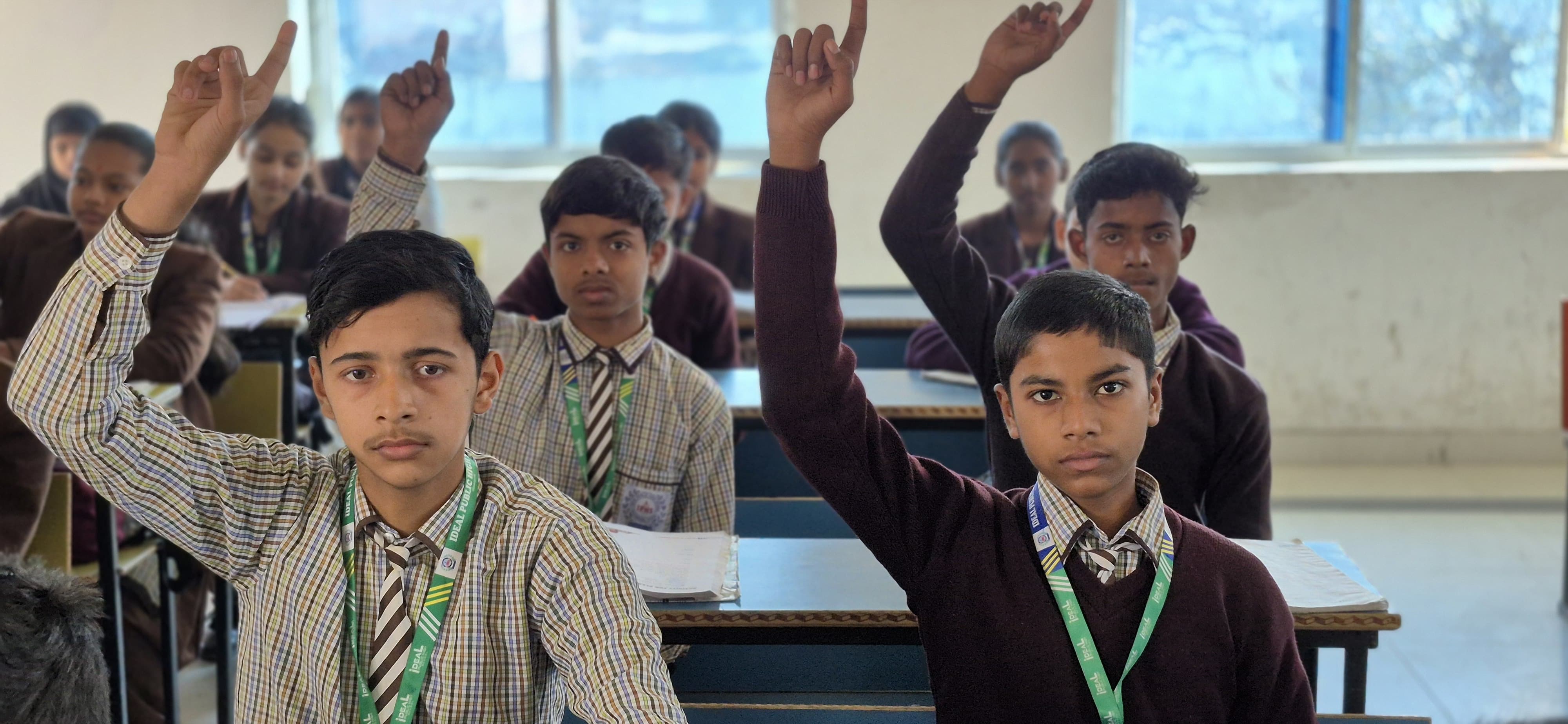 Students actively participating in class at Ideal Public School